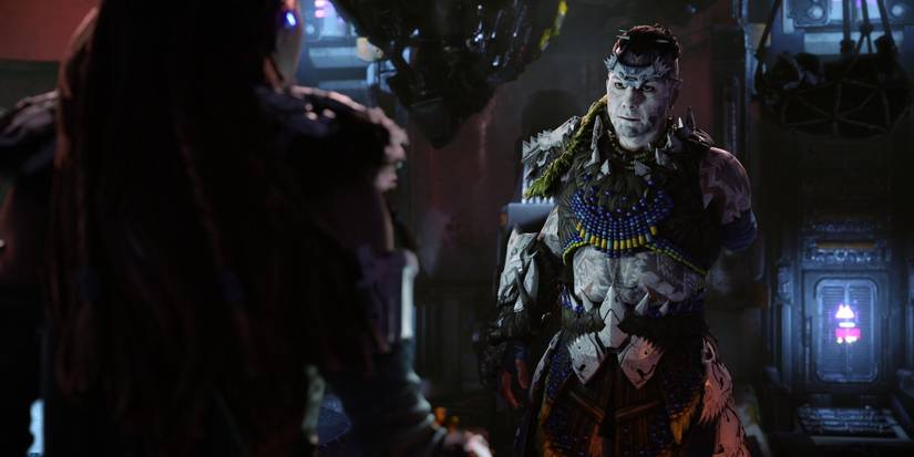 kotallo standing inside a dark room with a dim light shine on his blue and yellow armor and white body paint