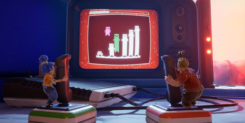 Cody and May both controlling characters on a screen in It Takes Two