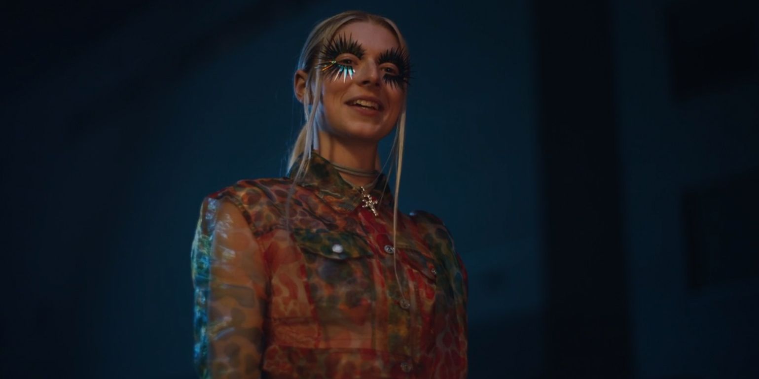 Jules' psychedelic art deco outfit with transparent jacket and metal fake eyelashes, in Euphoria Season 1