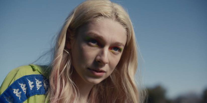 Euphoria's Jules wearing a Kappa track jacket with rainbow eye shadow.