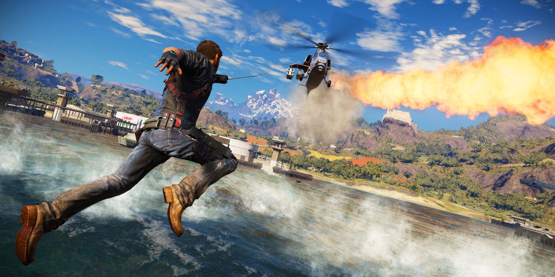 Rico Rodriguez grapples a burning helicopter in Just Cause 3 in Medici.