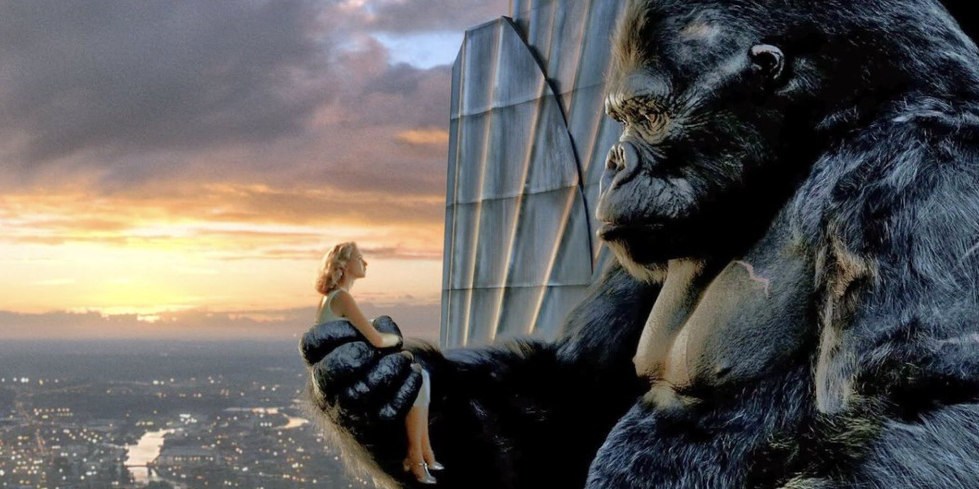 King Kong holding Naomi Watts in his hand over a cityscape