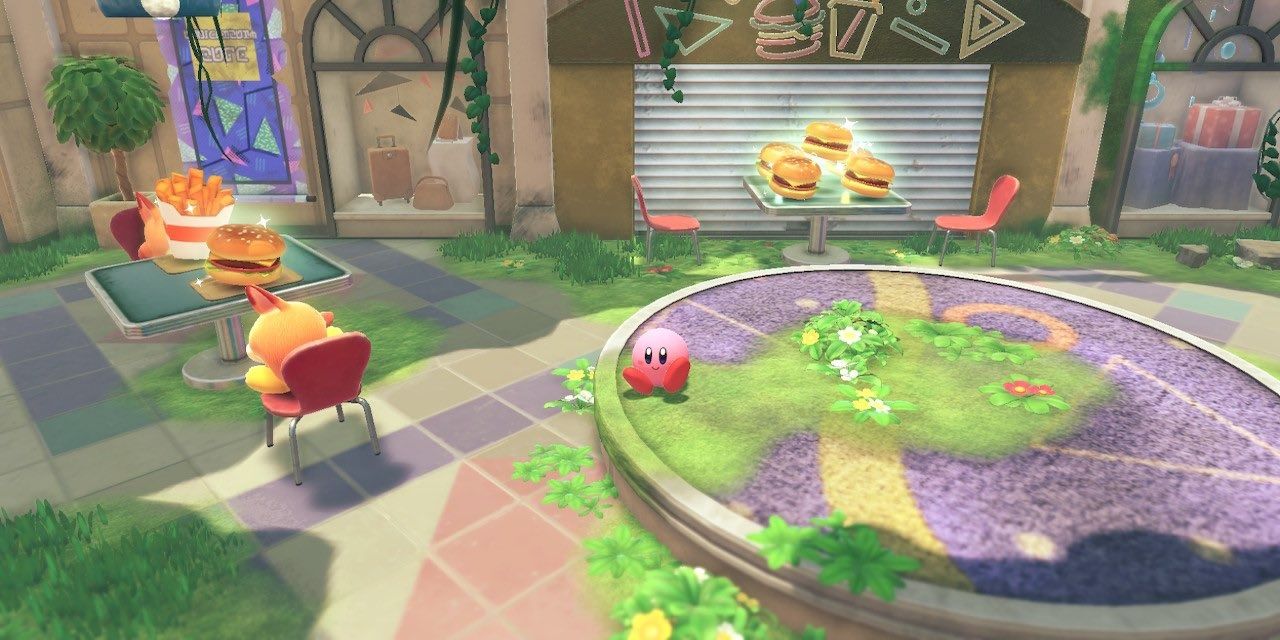 Kirby sitting in a food court of an abandoned mall in Kirby and the Forgotten Land