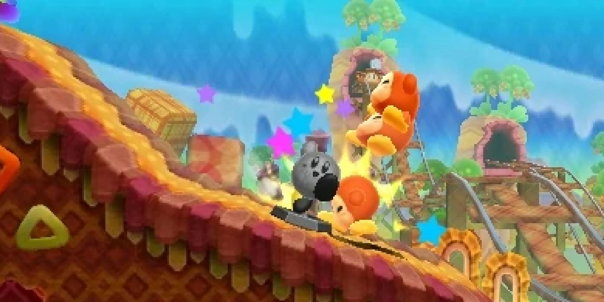 A statue of Kirby sliding down an incline hitting Waddle Dees in Kirby Triple Deluxe