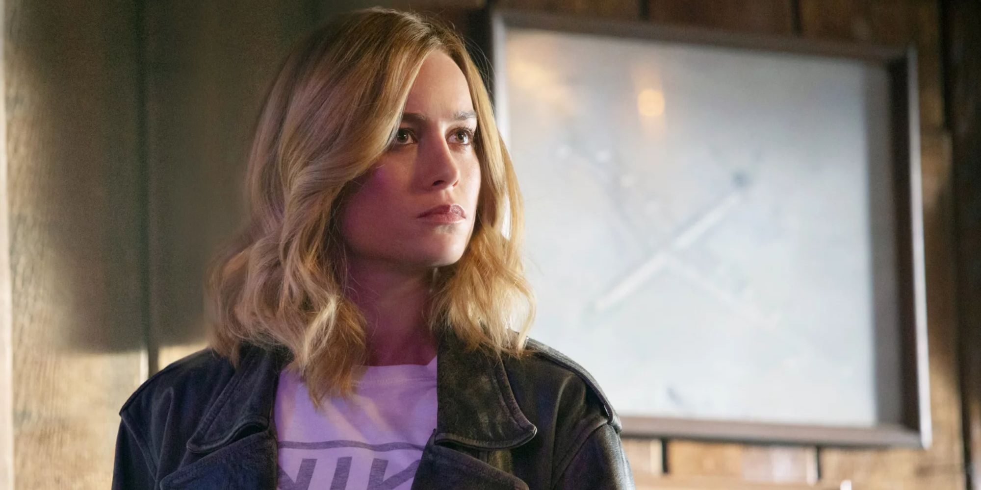 Brie Larson as Carol Danvers wearing a stolen Nine Inch Nails shirt and leather jacket