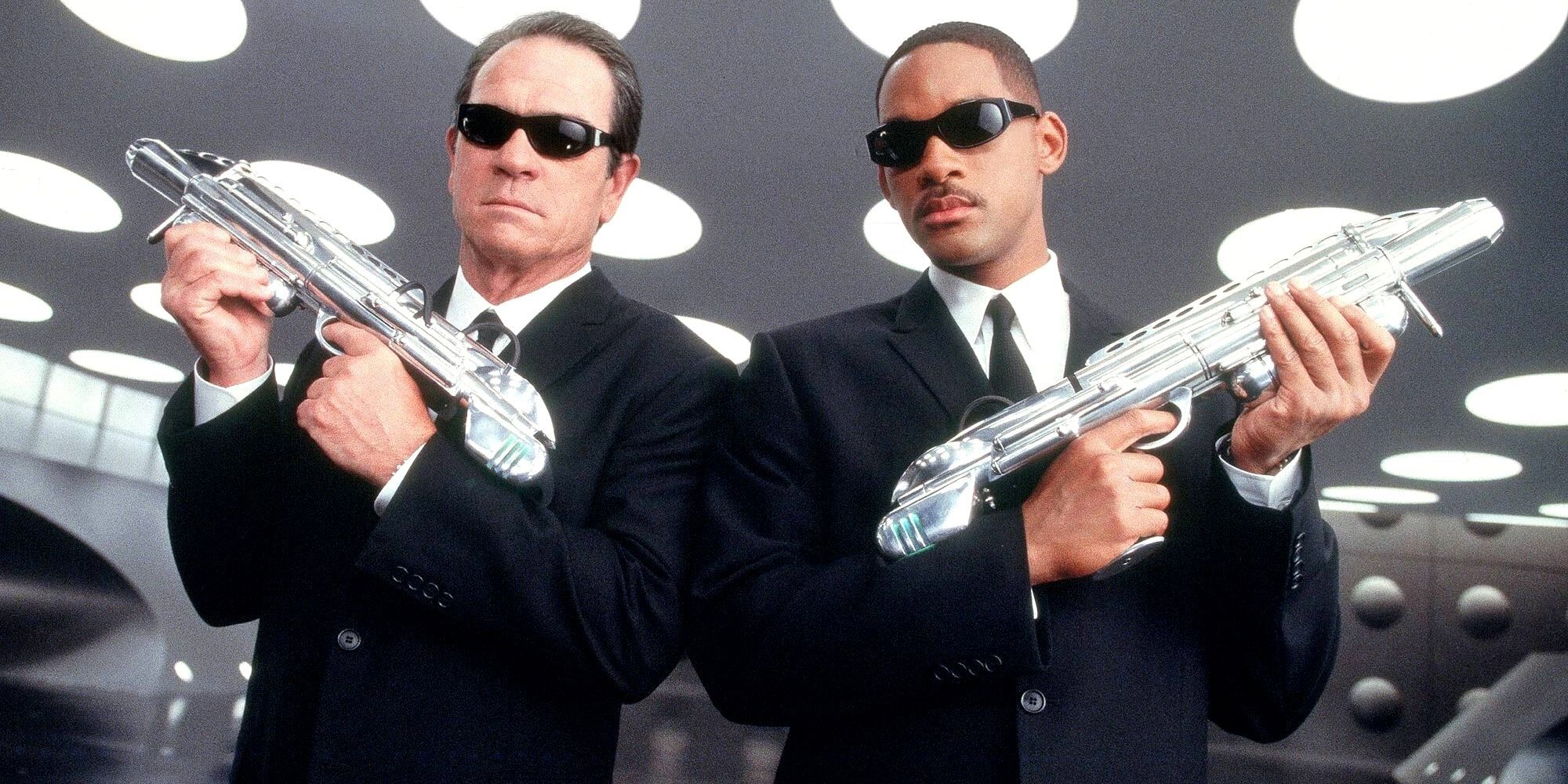 Men In Black Agent K and J Wearing Sunglasses And Holding Special Blaster Weapons