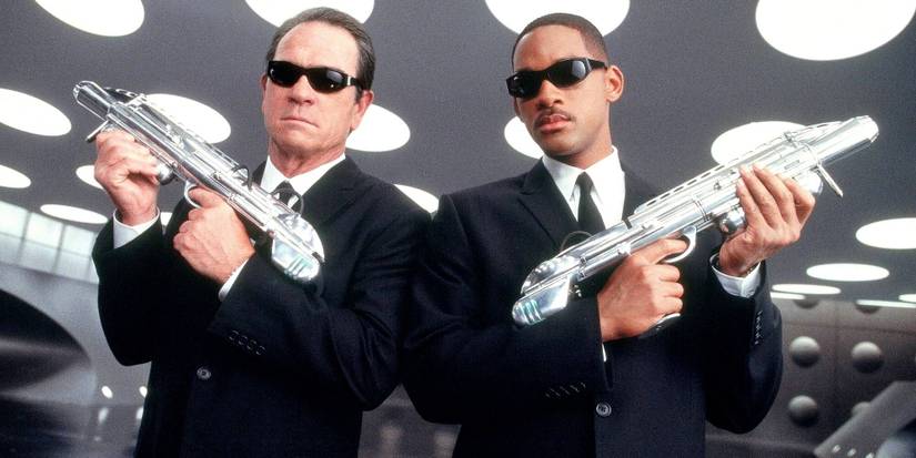 Men In Black Agent K and J Wearing Sunglasses And Holding Special Blaster Weapons