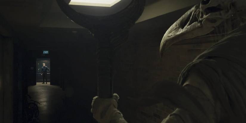 Steven staring at Khonshu at the other end of his apartment building's hallway