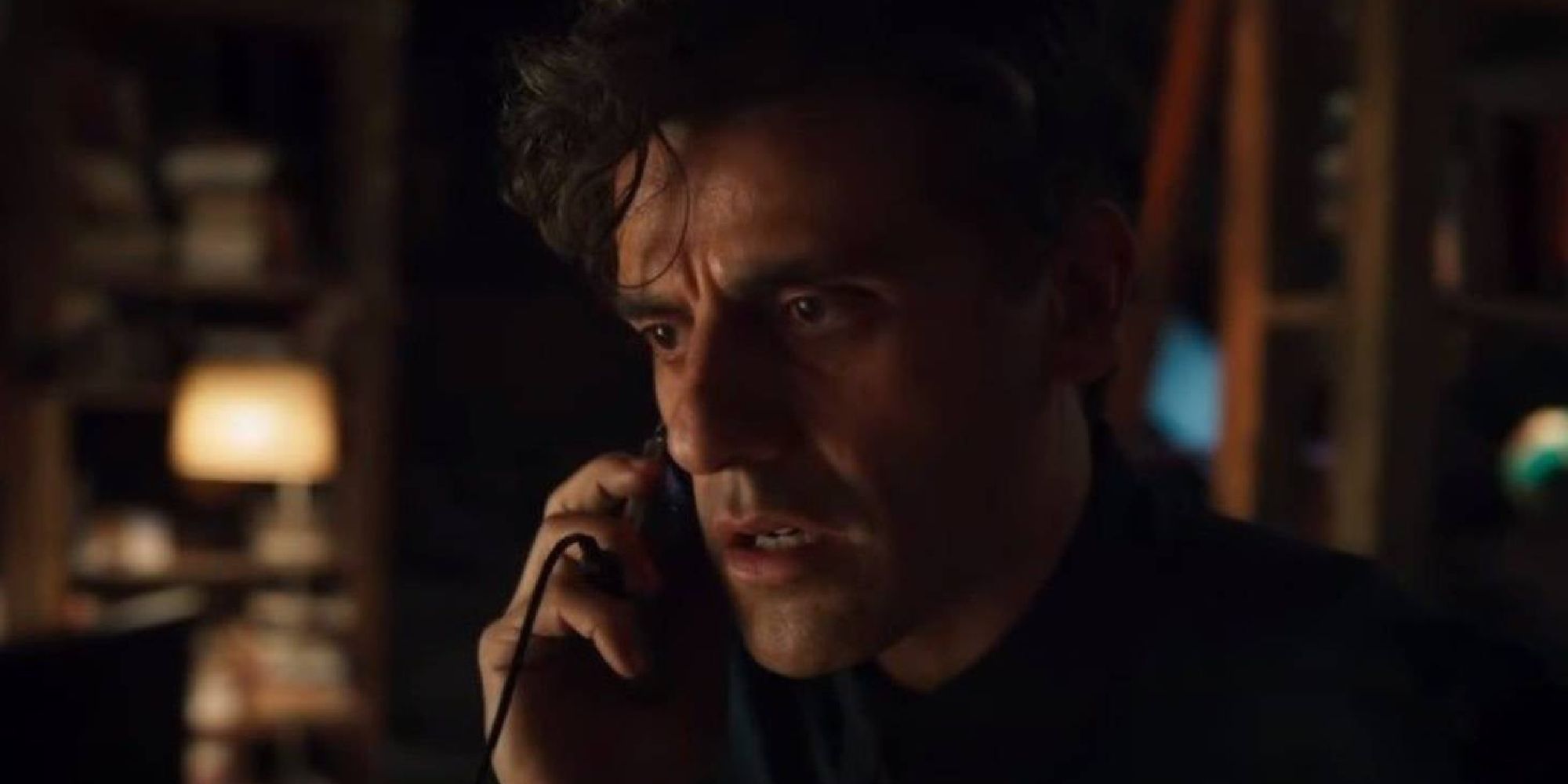 Oscar Isaac as Marc Spector receiving a disturbing phone call