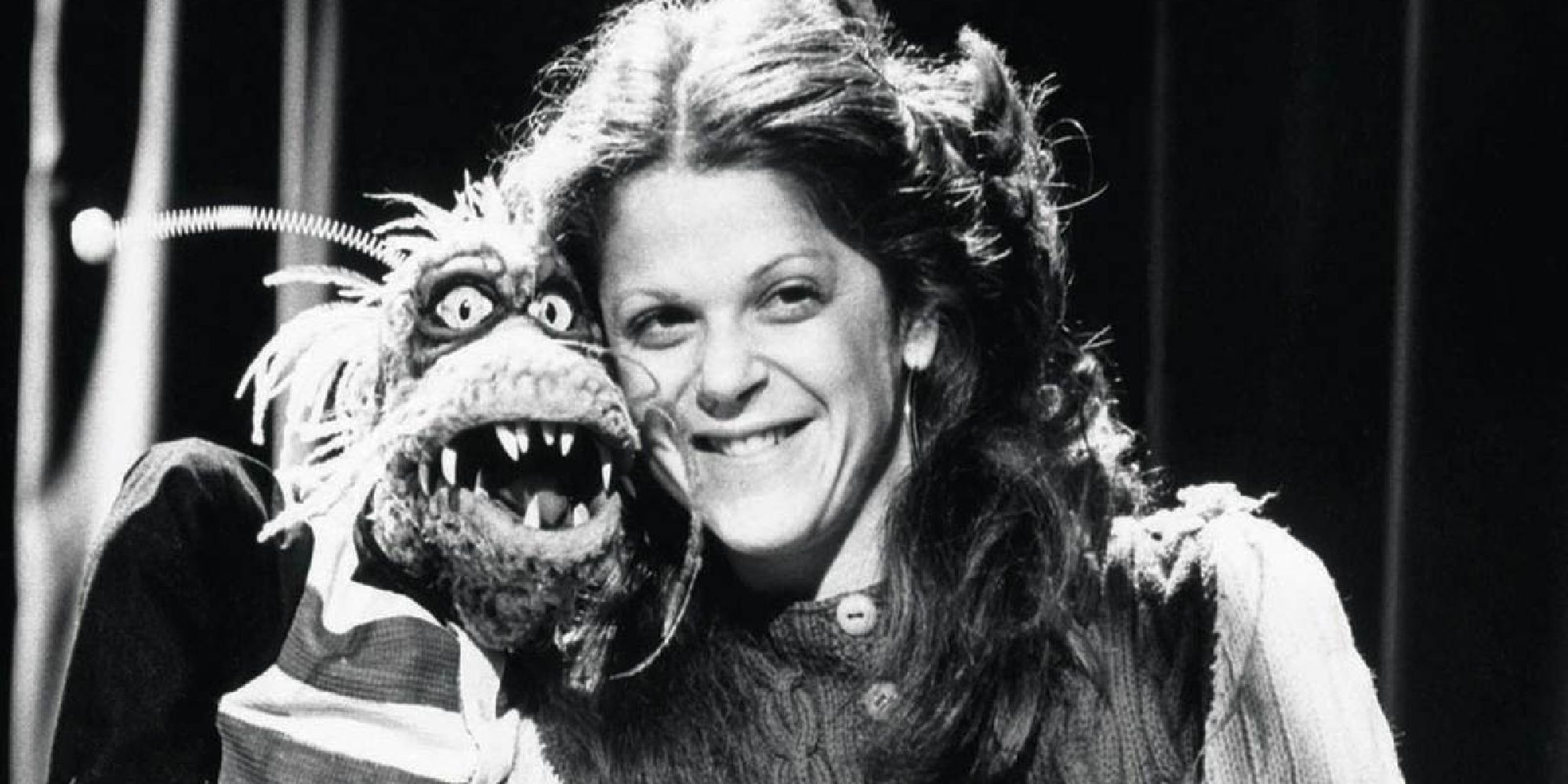 Gilda Radner posing with a Muppet behind the scenes