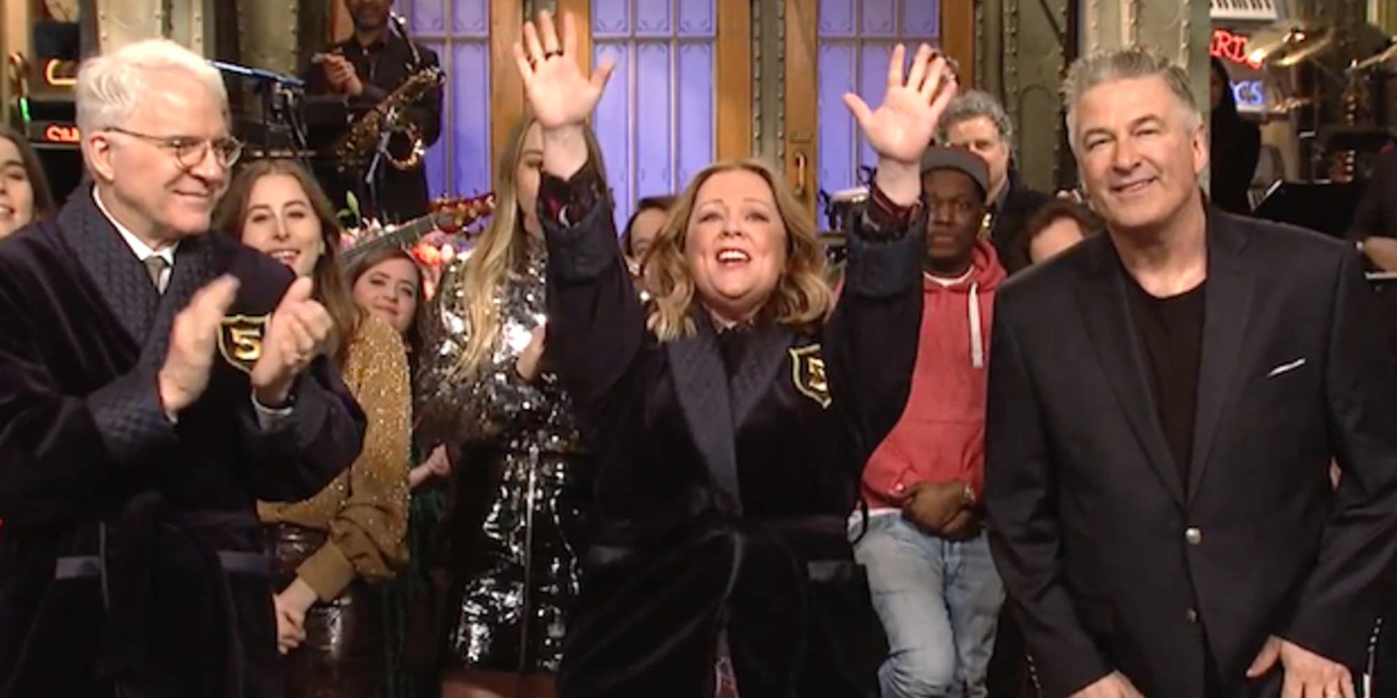 Melissa McCarthy in her Five-Timer jacket next to Steve Martin, Alec Baldwin, HAIM, and the SNL Cast