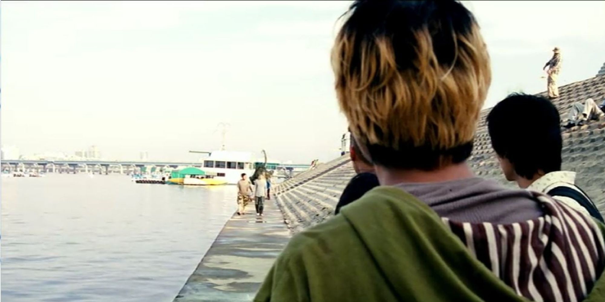 Song Kang-ho watching the monster approach him and others from across a coastline