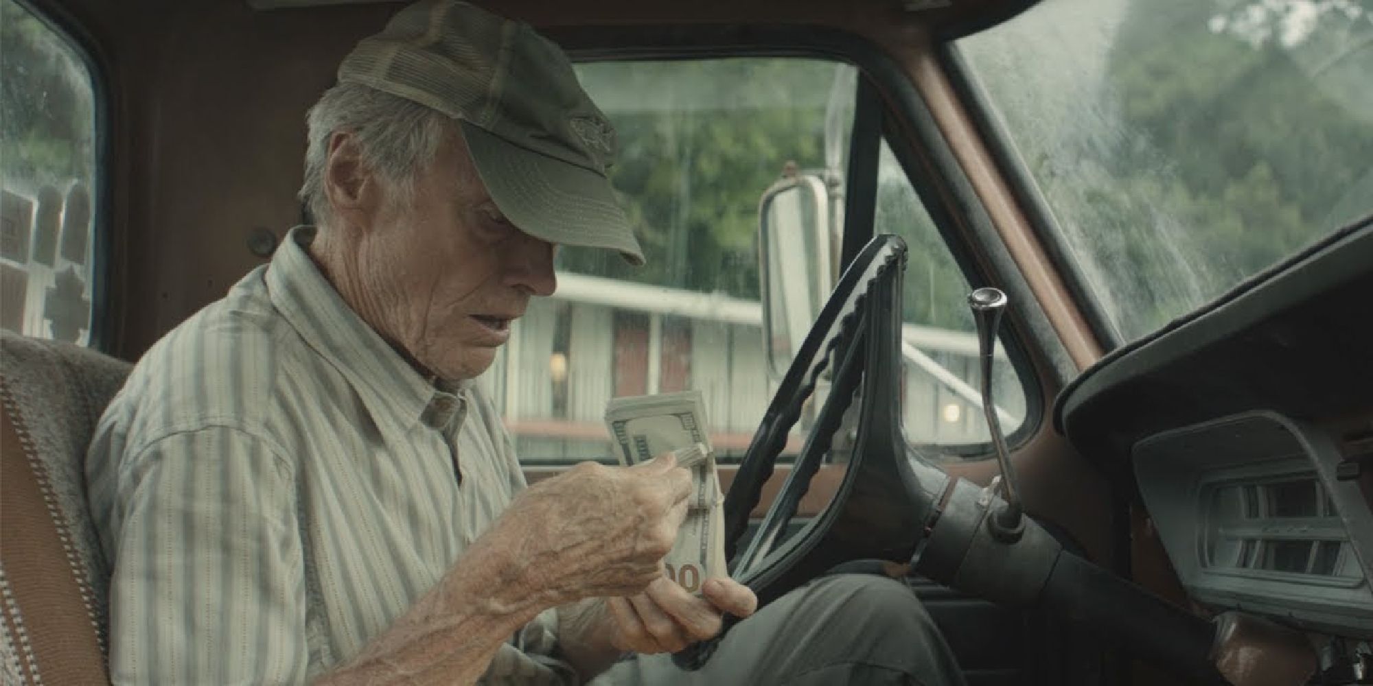 Clint Eastwood counting money in his car in The Mule