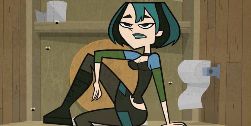 Gwen giving an interview to the camera in a toilet