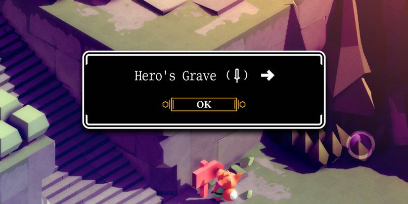 a large, black and white text box read "Hero's Grave" followed by a small image of a sword and an arrow pointing to the right. Underneath the box is small, red fox in a green tunic looking up at the text box as if he can see it