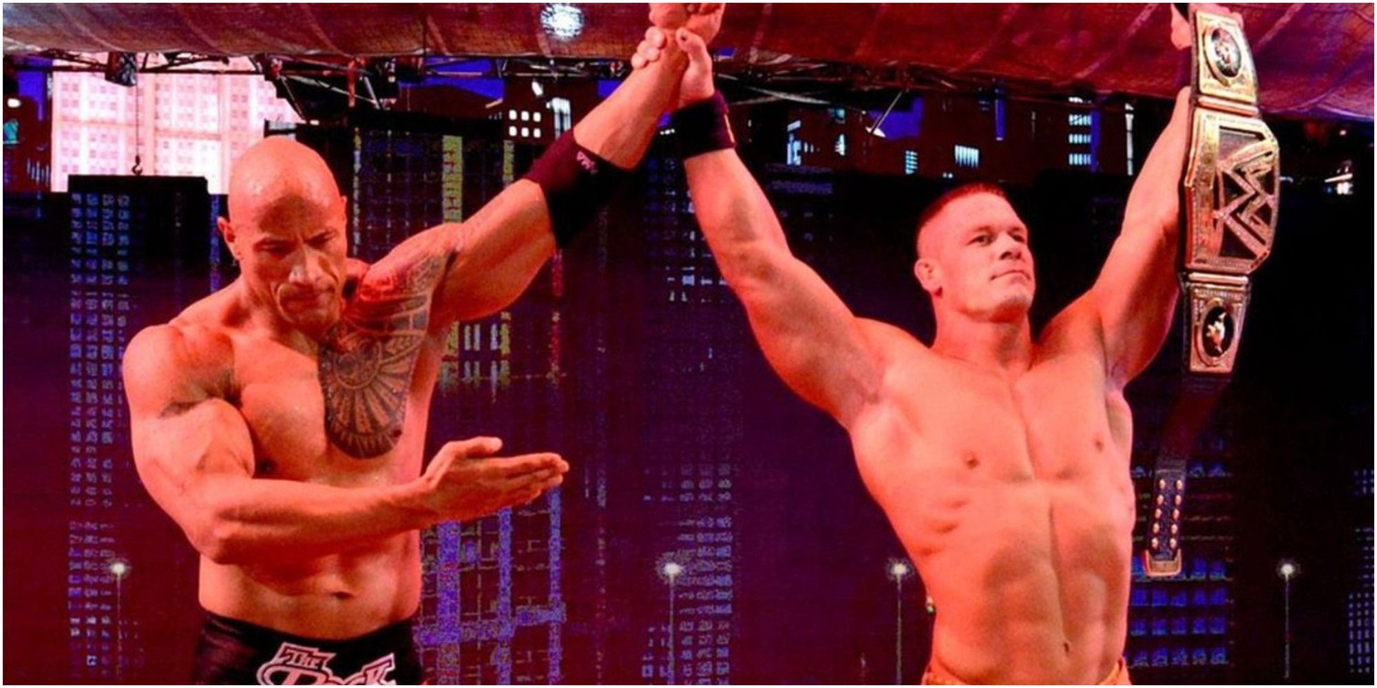 WWE Cena with hand raised by The Rock