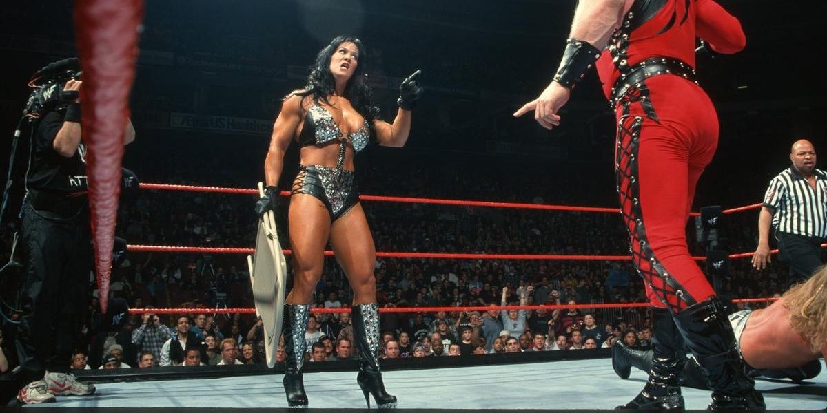 WWE Chyna holding a chair, staring down Kane