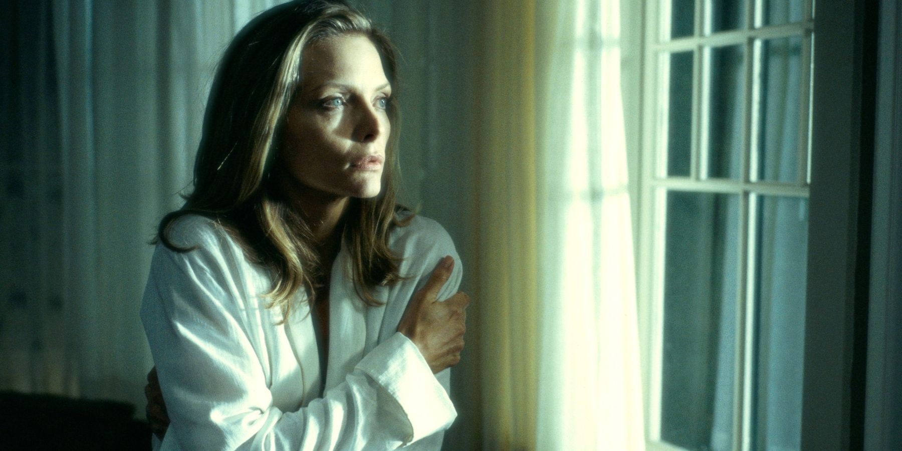 Клэр (Мишель Пфайффер) смотрит в окно в фильме «Что скрывает ложь».