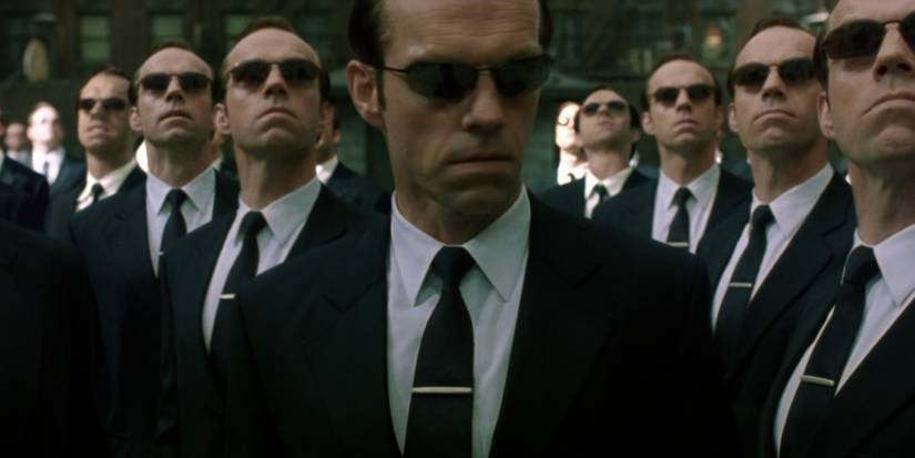 The Matrix Reloaded army of Smiths looking on