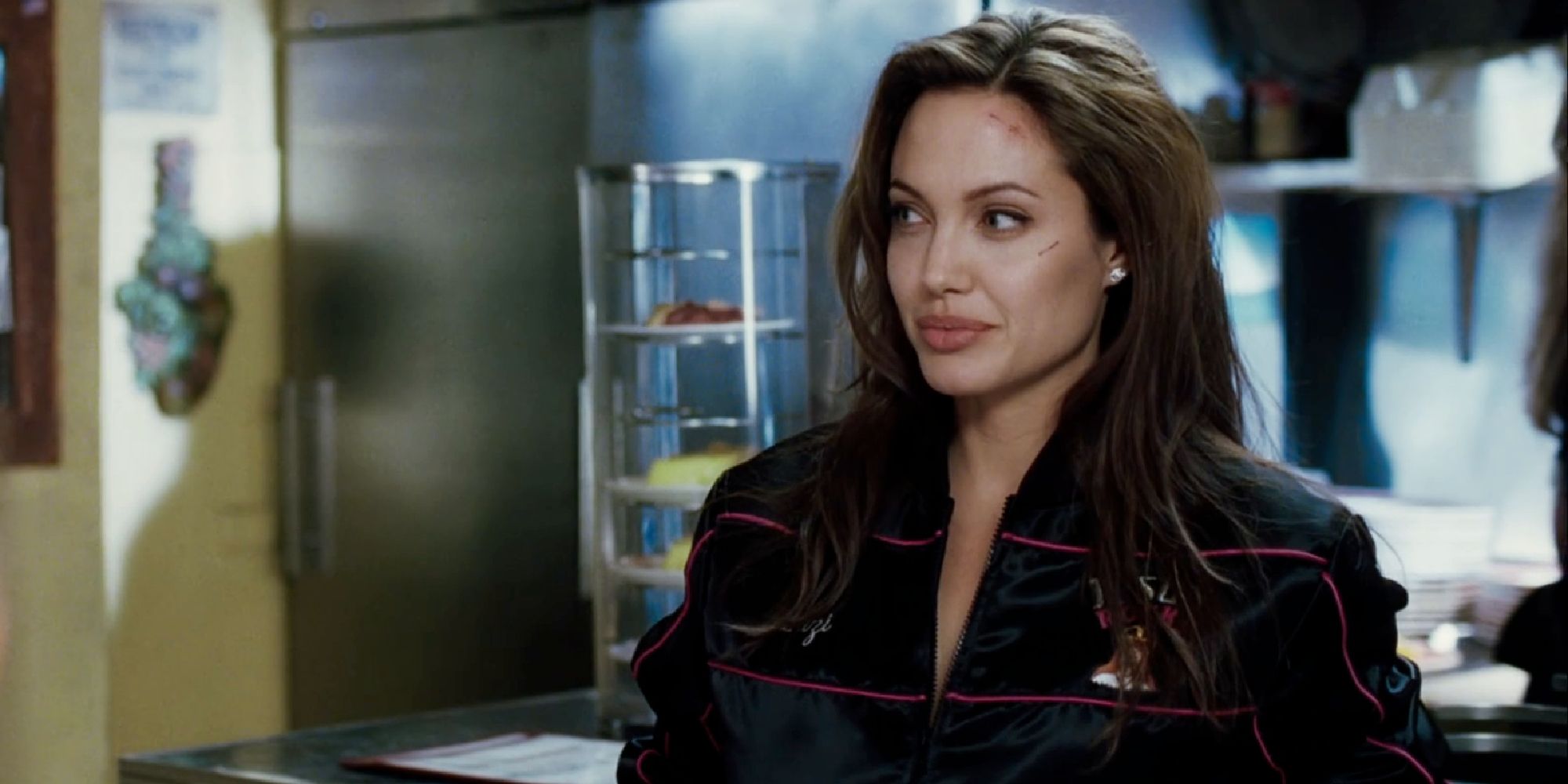 Angelina Jolie wearing a tracksuit in a kitchen in Mr. & Mrs. Smith