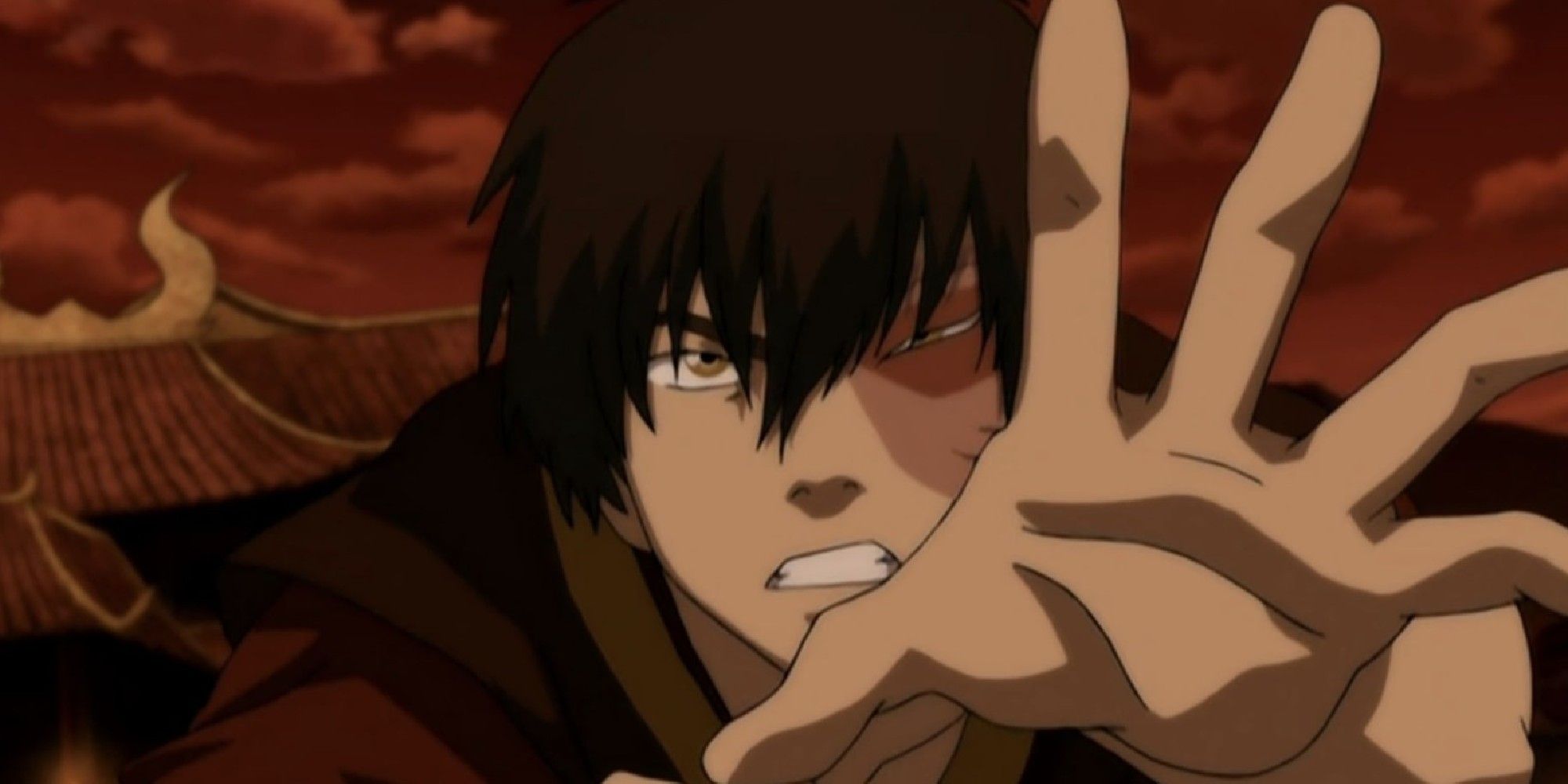 Zuko reaching his hand out in front of a red sky