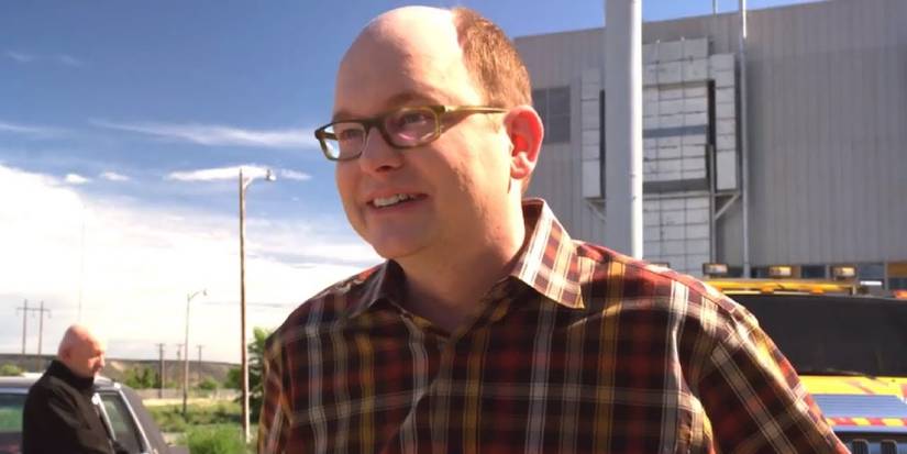 Daniel Wormald smiling in front of his yellow Hummer with Mike in the background
