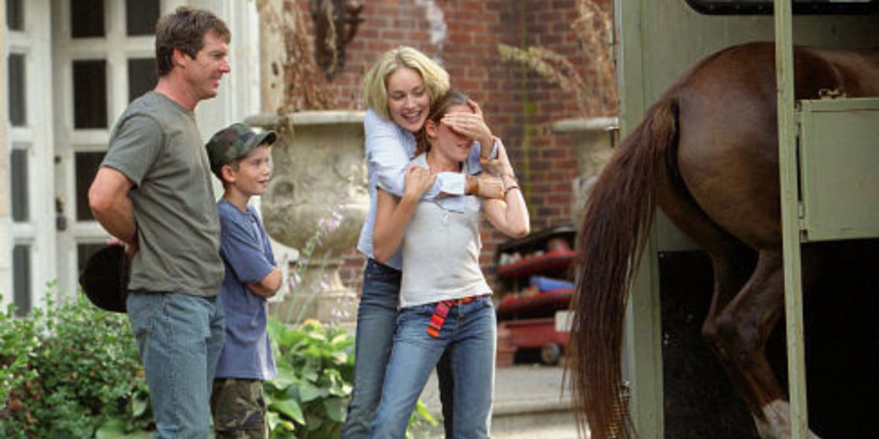 The family in Cold Creek Manor standing outside of their house