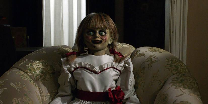 Annabelle the doll sitting in a chair