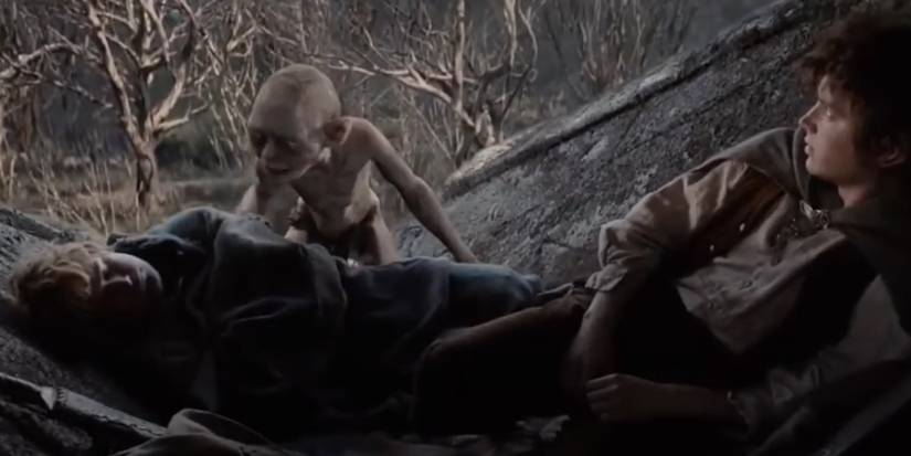 Gollum watches Frodo and Sam sleeping