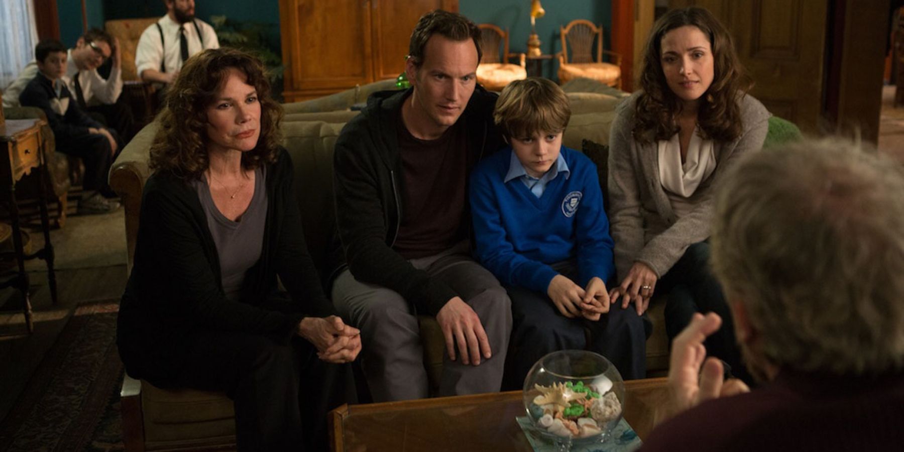 The Lambert family sitting on a couch in Insidious: Chapter 2