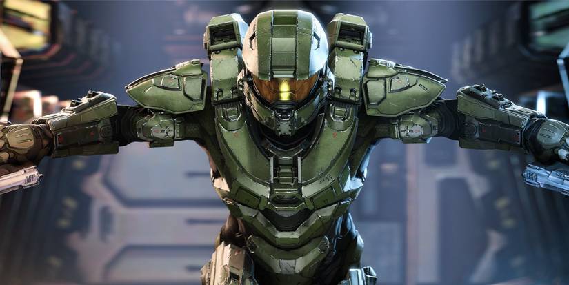 Master Chief in Halo Infinite with guns ready 