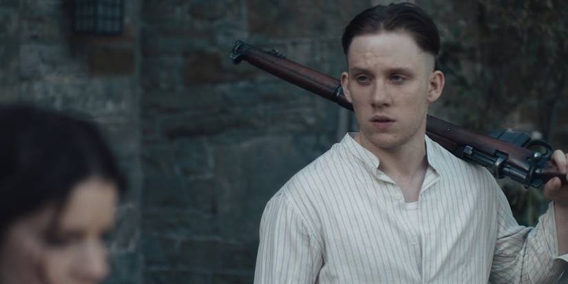 John Shelby carrying a gun