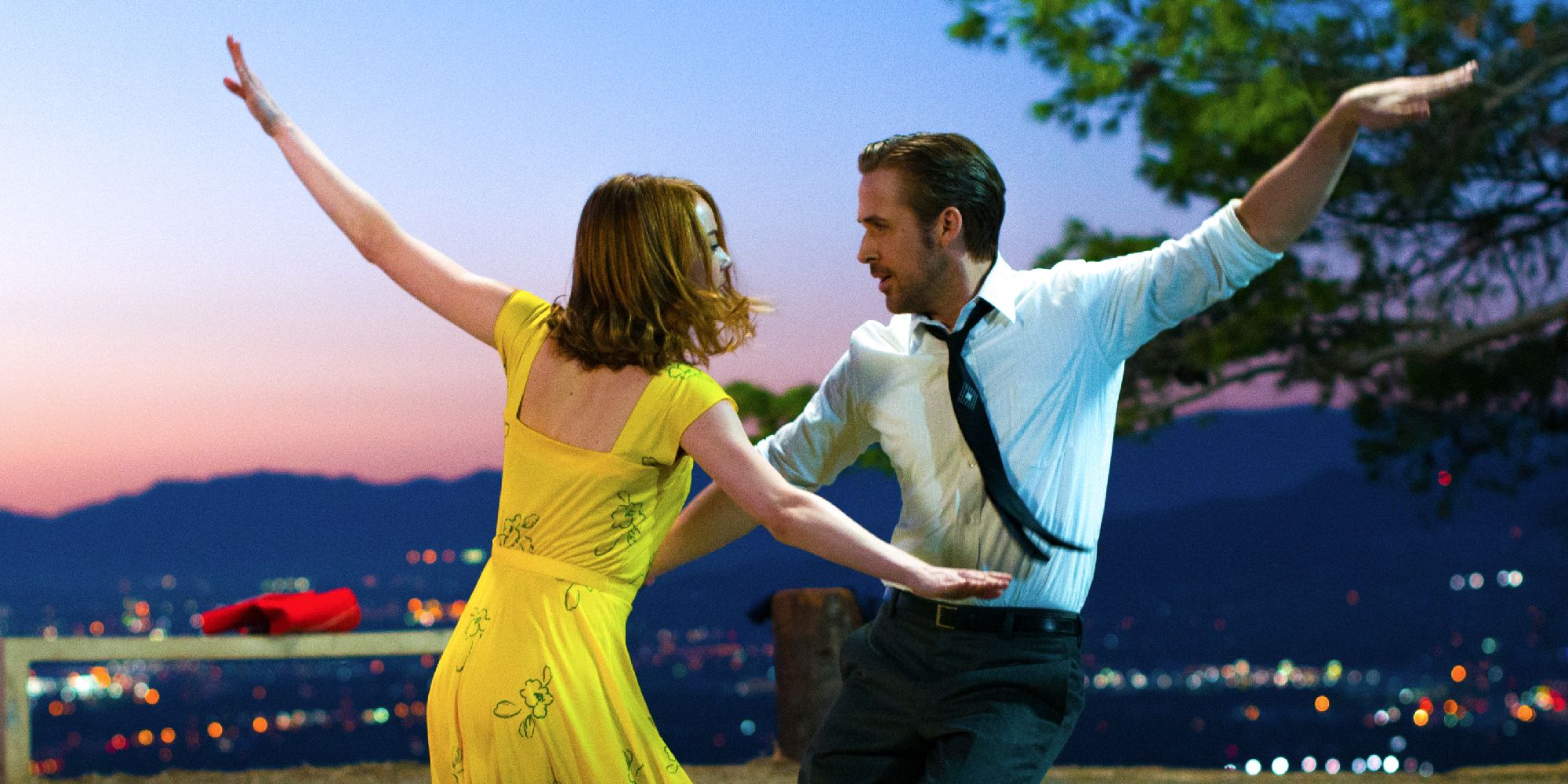 Emma Stone and Ryan Gosling dancing in front of the skyline of LA in La La Land