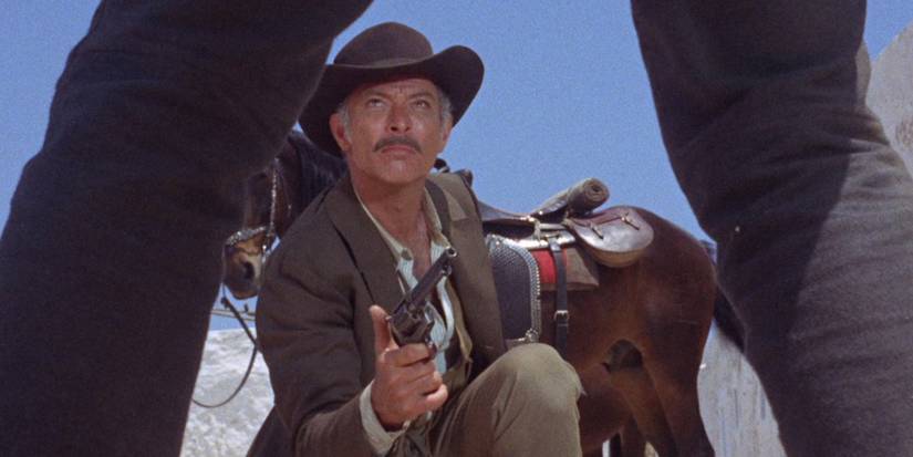 Lee Van Cleef shoots between his protege's legs in Day of Anger