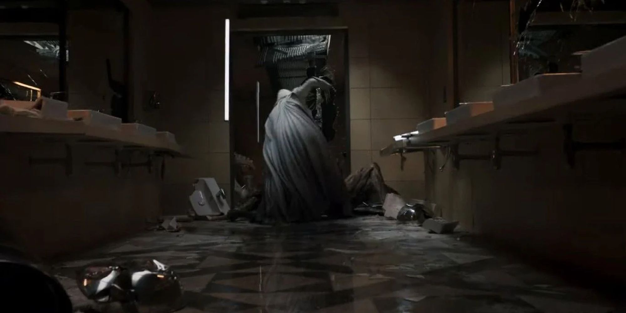 Moon Knight beating the jackal-like creature in the museum bathroom