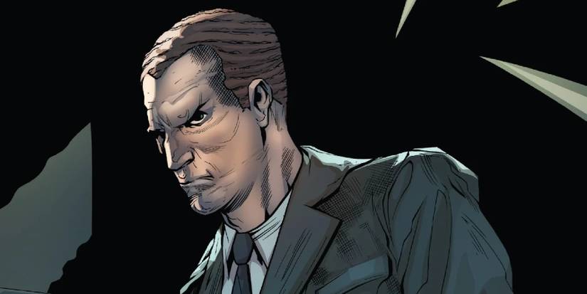 Norman Osborn standing in the dark grimacing