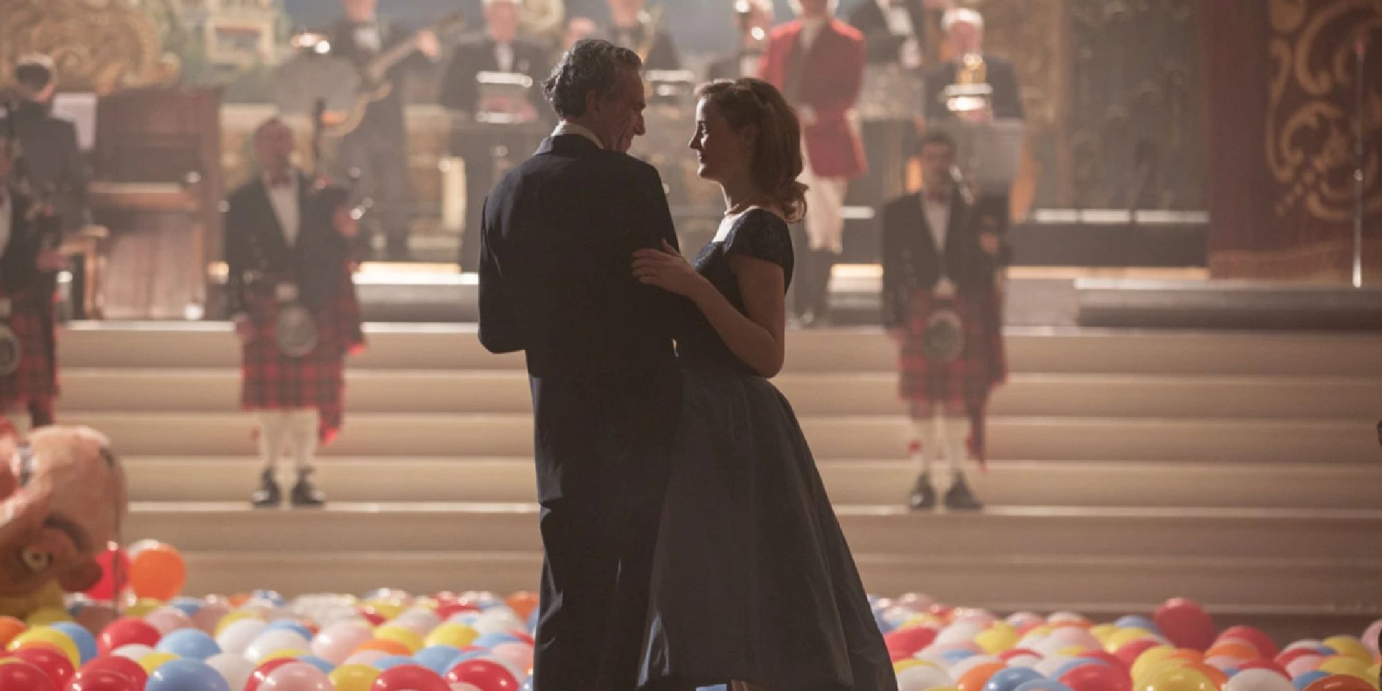 Daniel Day-Lewis and Vicky Krieps dancing in a ballroom in Phantom Thread