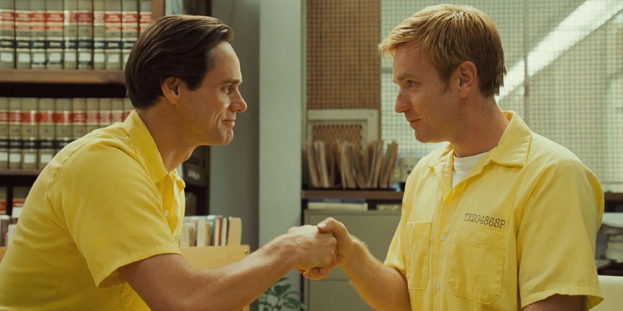 Jim Carrey and Ewan McGregor as prison inmates shaking hands in I Love You Phillip Morris