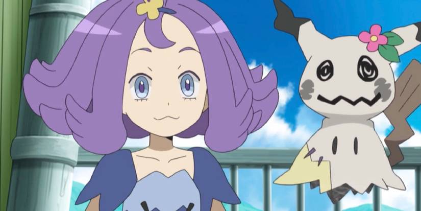 Acerola standing next to her greyscale Mimikyu with a flower on its head