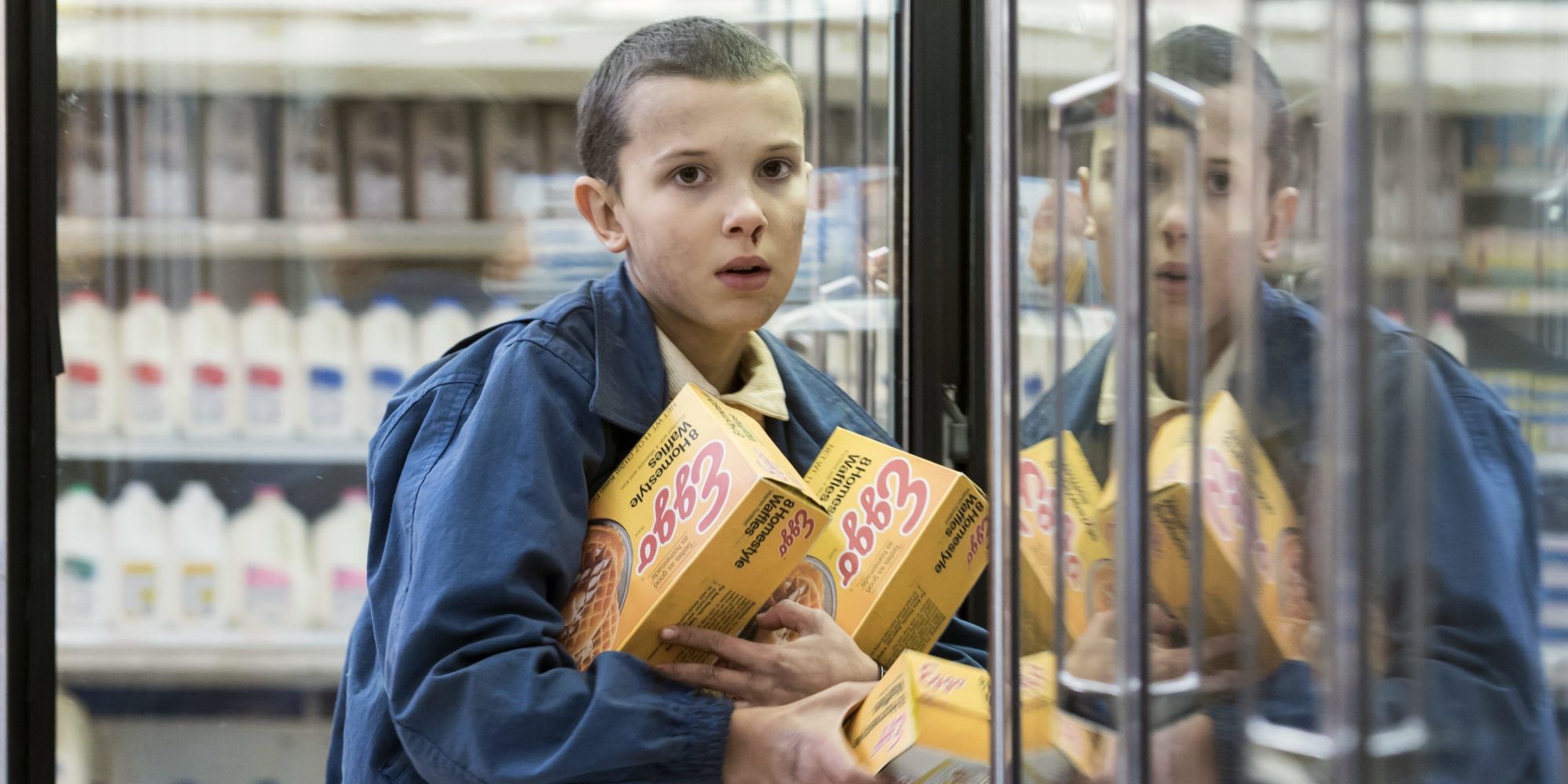 Eleven with an armful of Eggo boxes in season 1