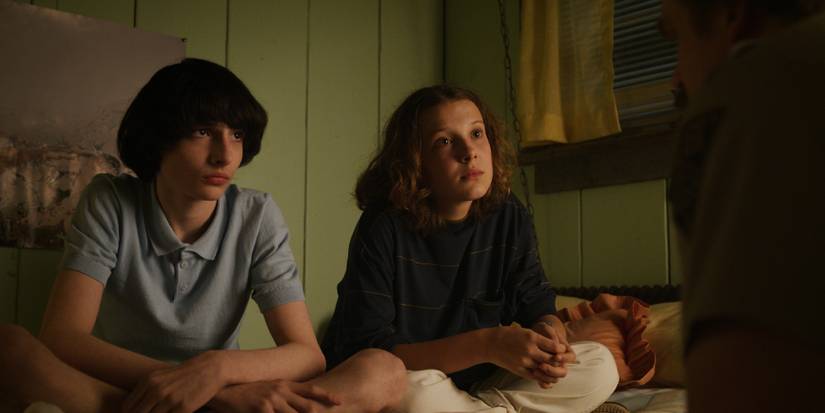 Mike and Eleven awkwardly staring at Hopper