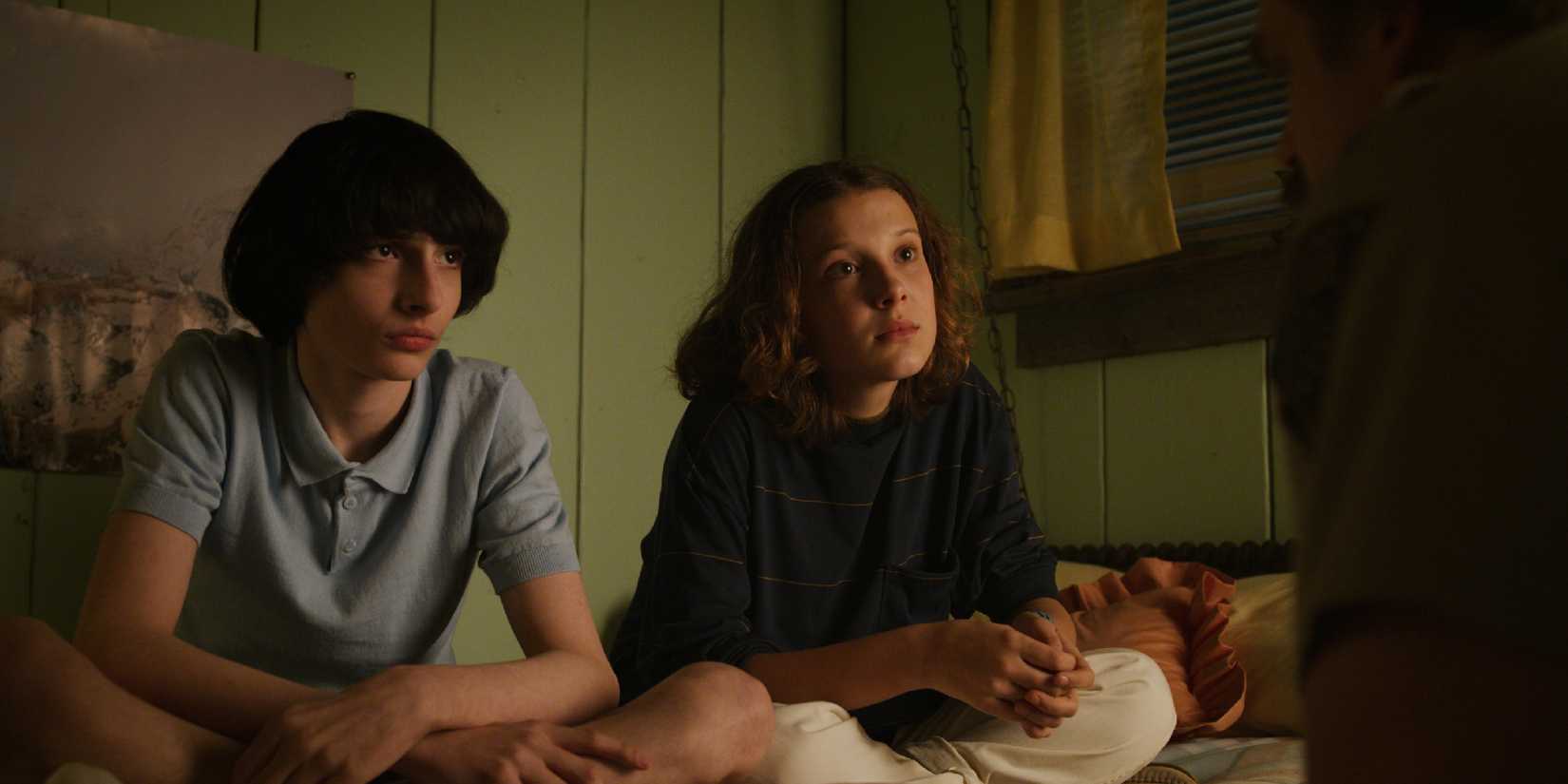 Mike and Eleven awkwardly staring at Hopper