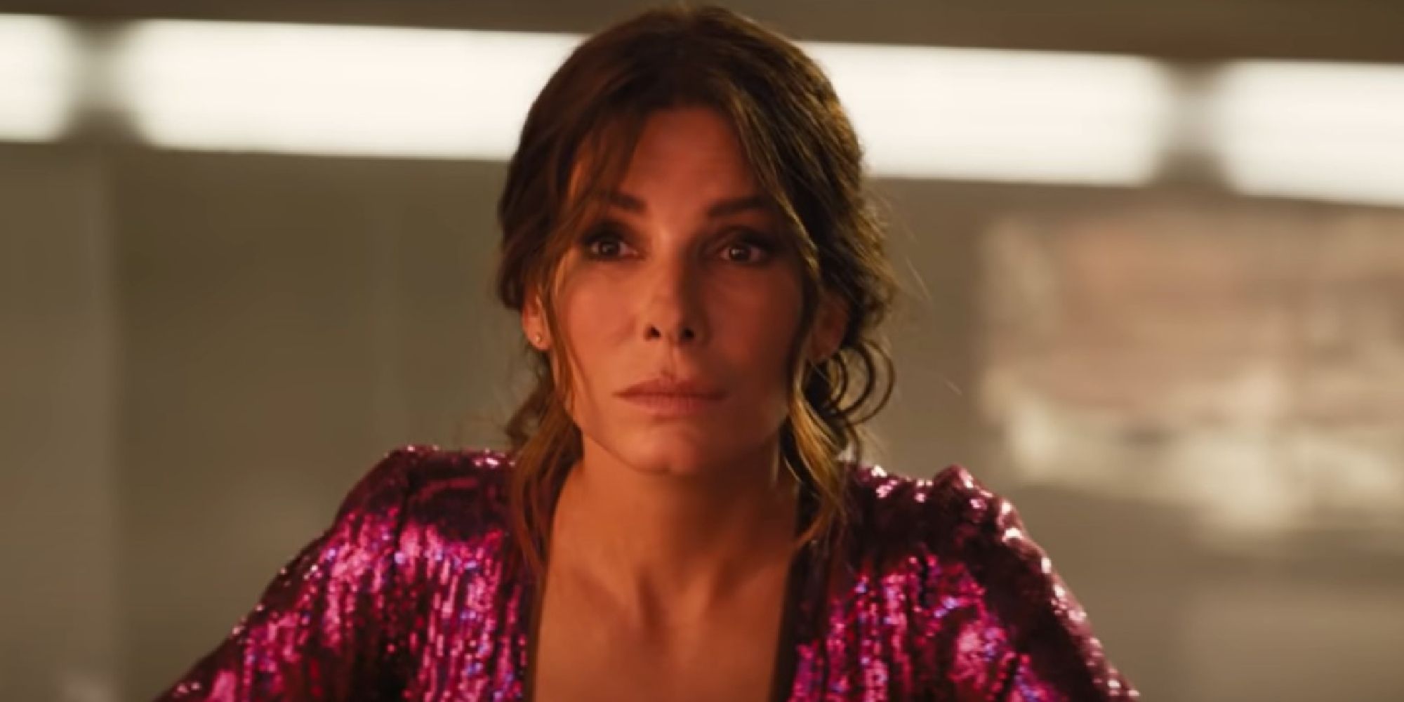 Sandra Bullock wearing a pink sparkly dress in The Lost City