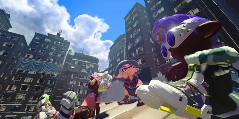 Three Inklings sitting on a rooftop in Splatoon 3