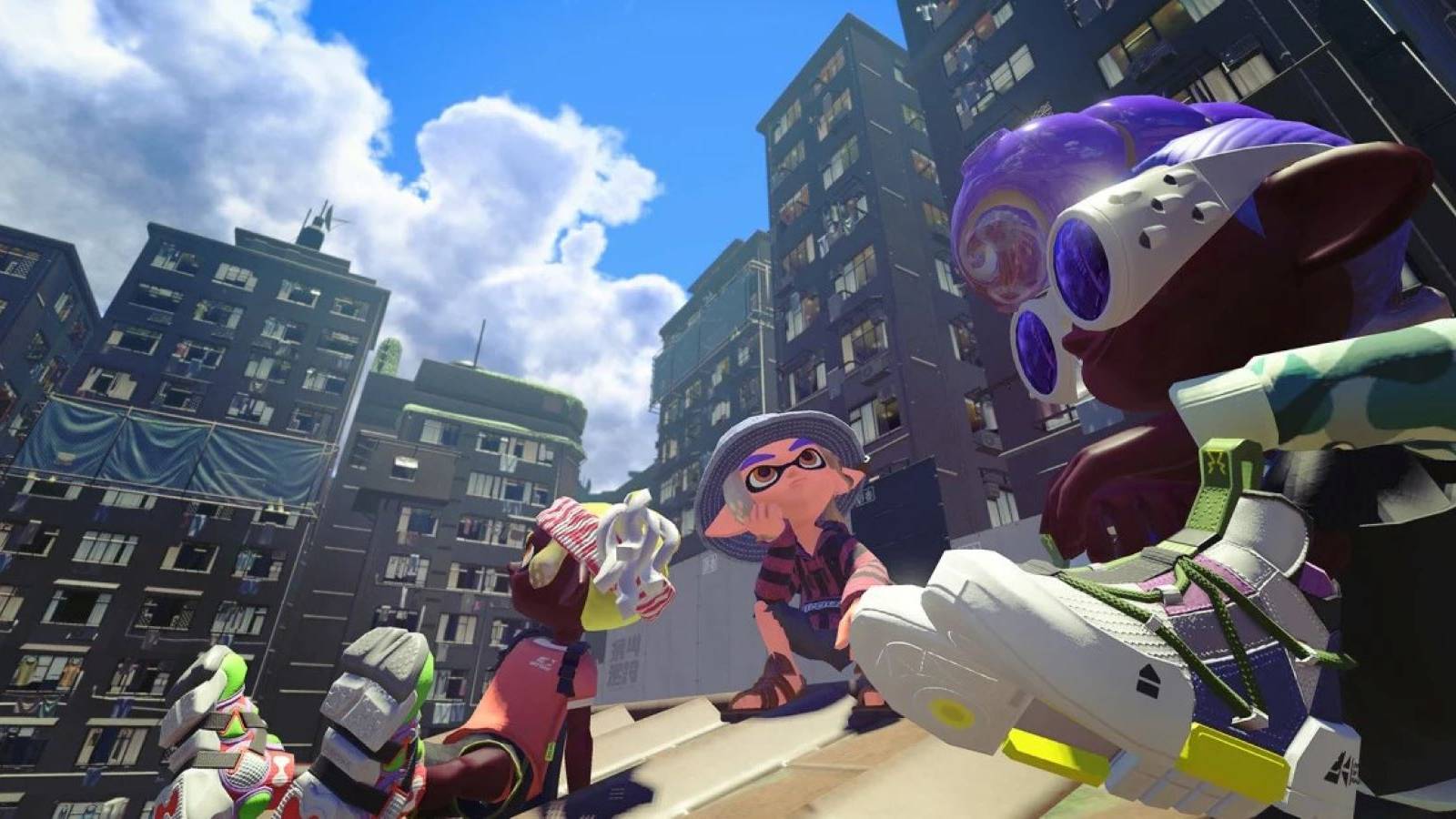 Three Inklings sitting on a rooftop in Splatoon 3