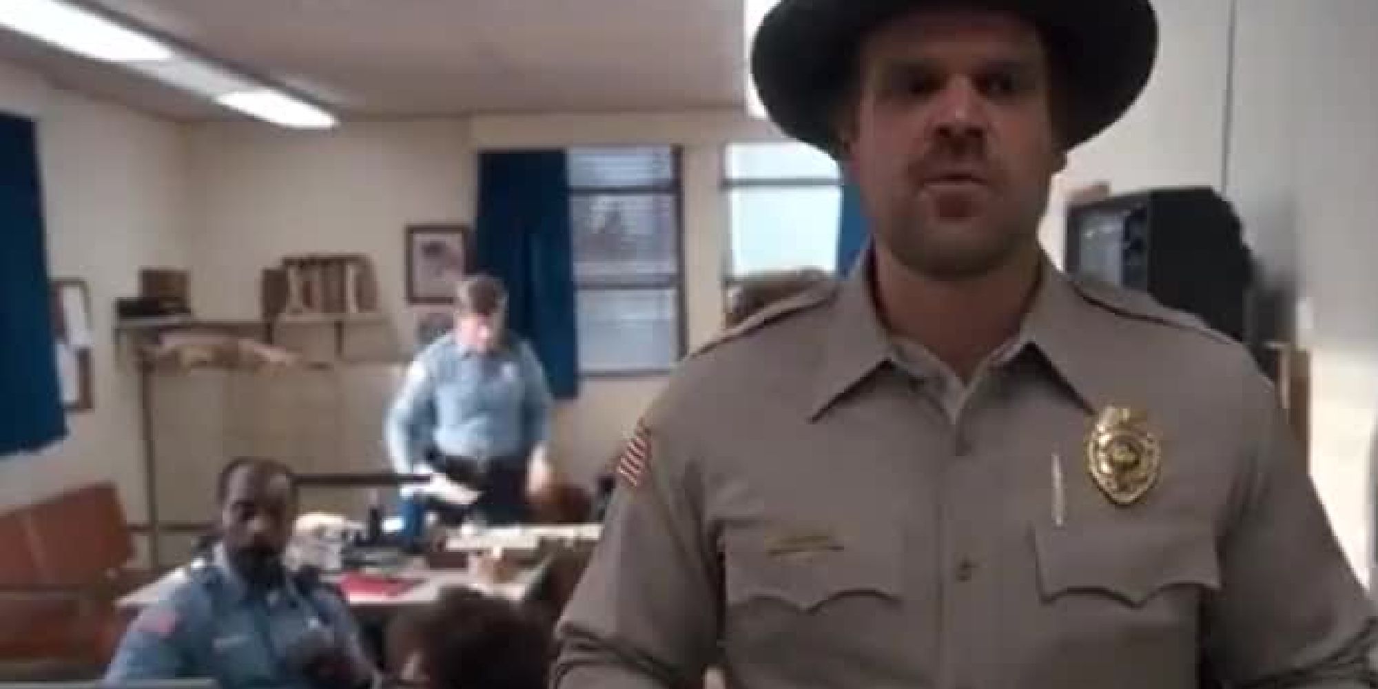 Hopper passing through Hawkins Police Station in the first episode of Stranger Things