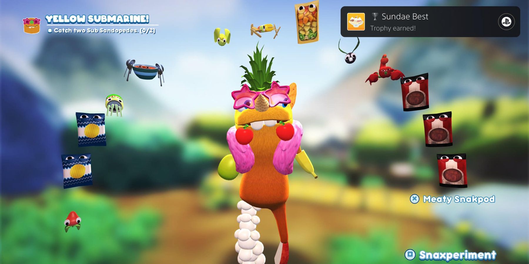 a grumpus with an orange body and various food limbs stands under an arch of bugsnax. in the top right corner is a playstation trophy notification titled Sundae Best 