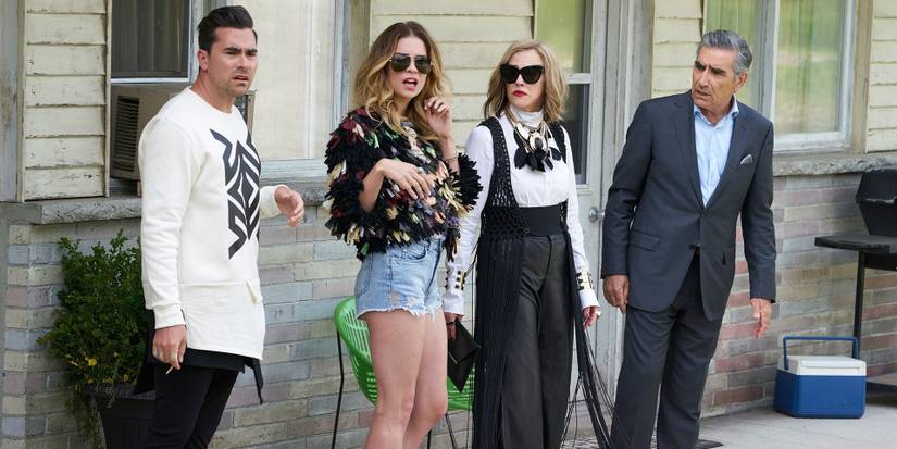 The Rose family standing outside the motel in Schitt's Creek