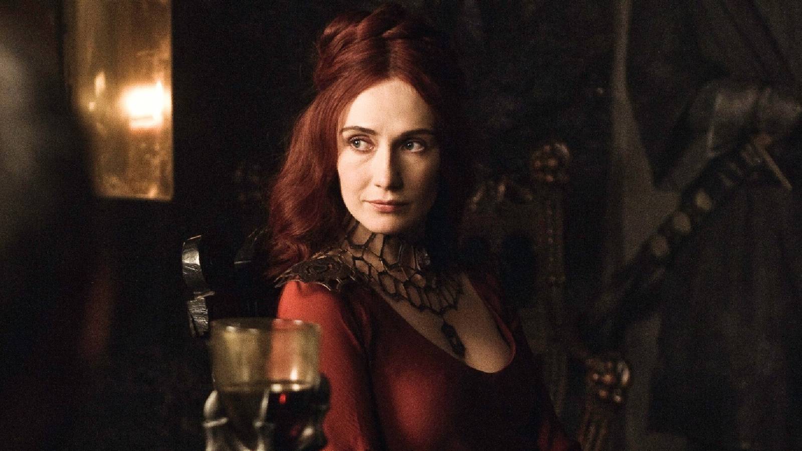 Melisandre sitting at a table with Stannis Baratheon