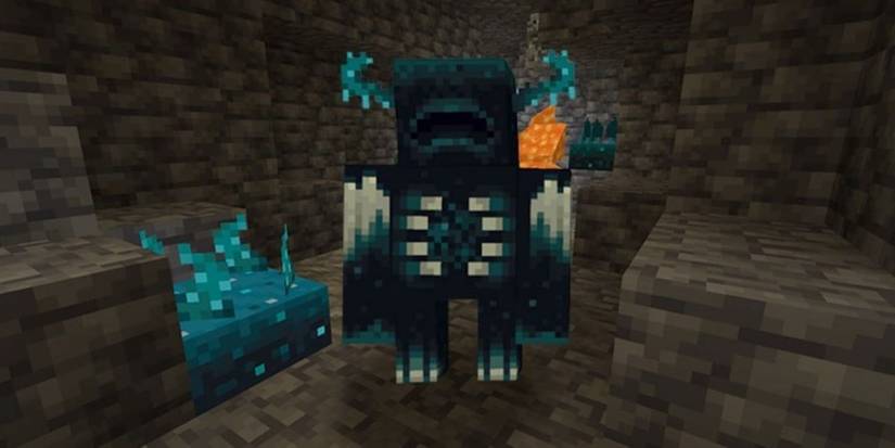 A Minecraft Warden standing near some Sculk blocks in a cave